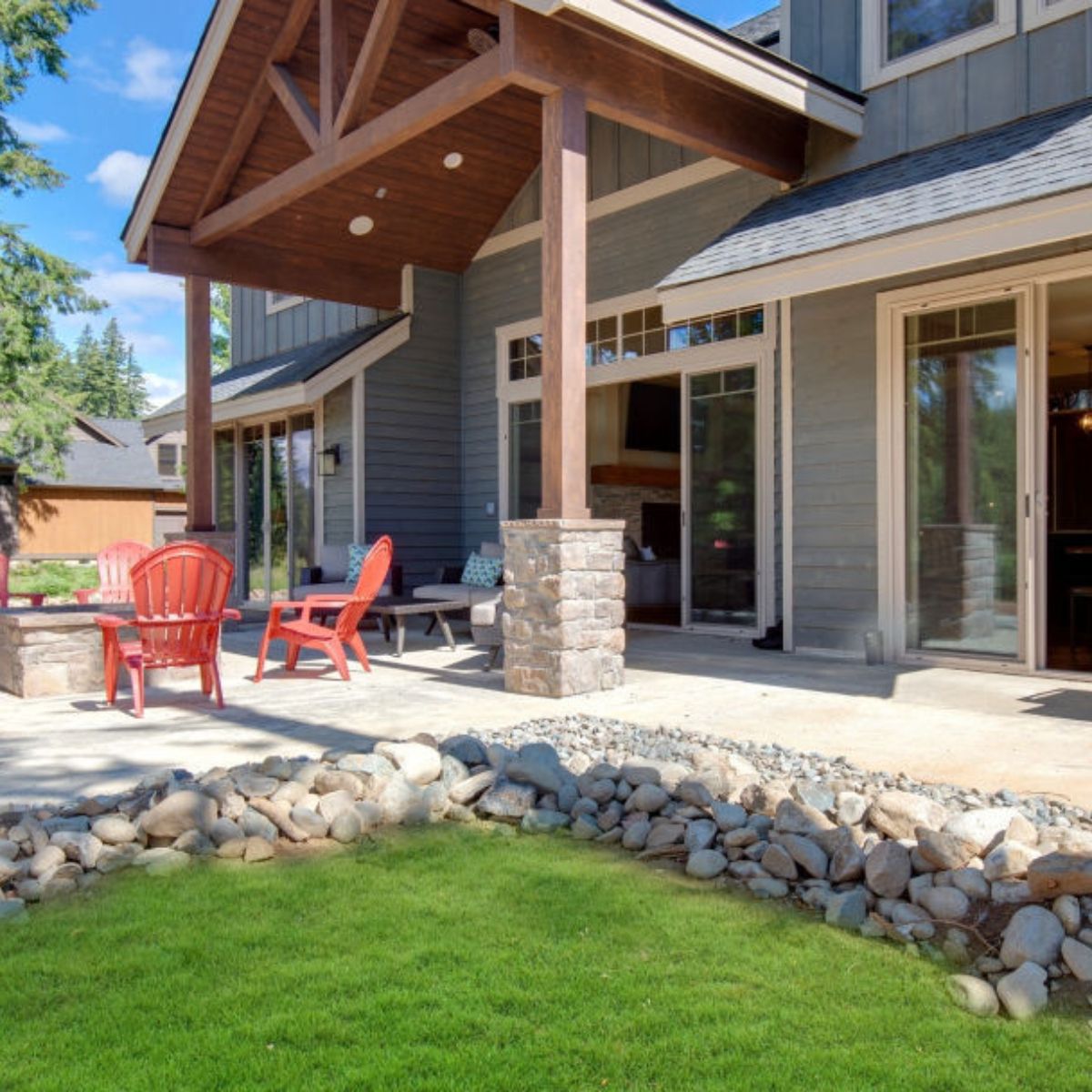 A house with a covered porch and red chairs