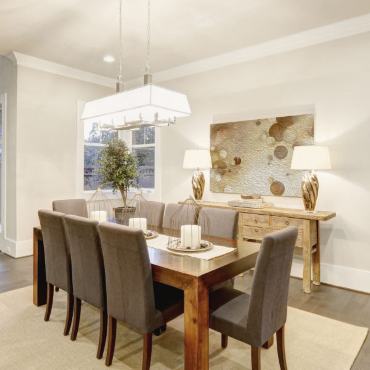A dining room with a long table and chairs
