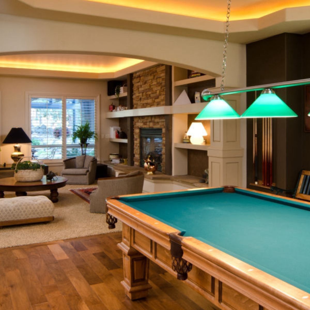 A pool table is in the middle of a living room